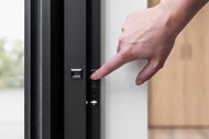 Woman using on-unit controls on automated window