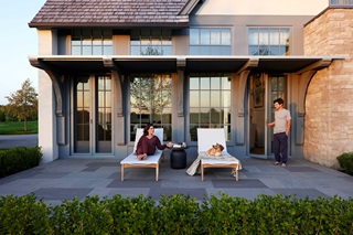 Two people on porch in front of home with Marvin Ultimate Windows and Doors