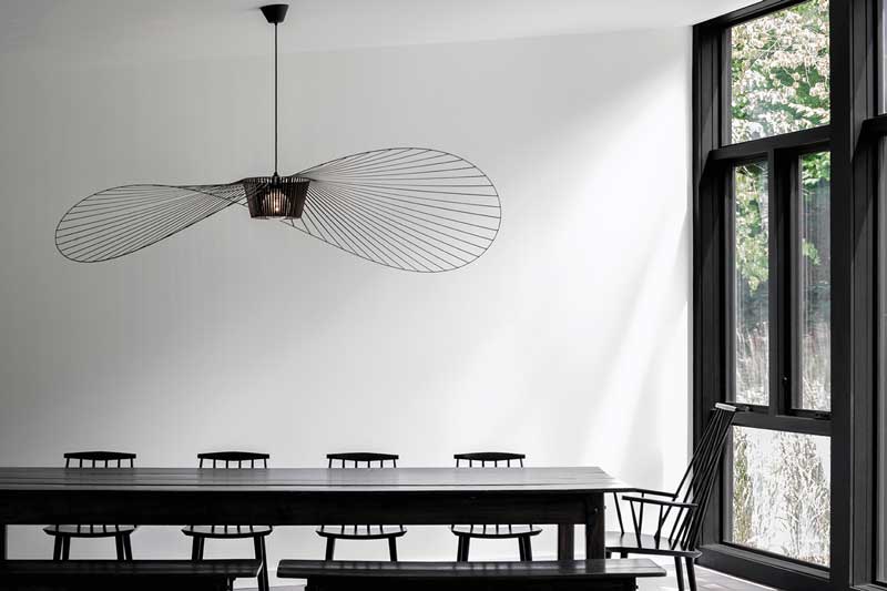 A modern black dining room with Marvin Elevate windows.